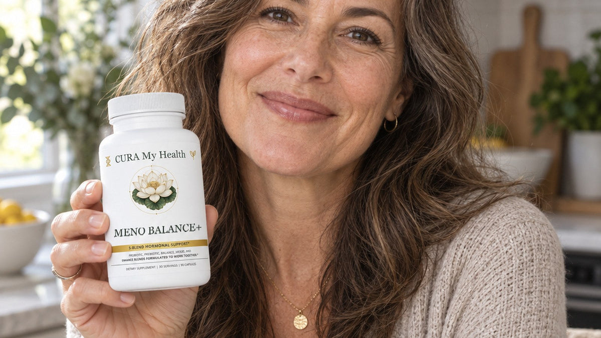 A smiling woman holding a Meno Balance+ bottle in a sunny kitchen