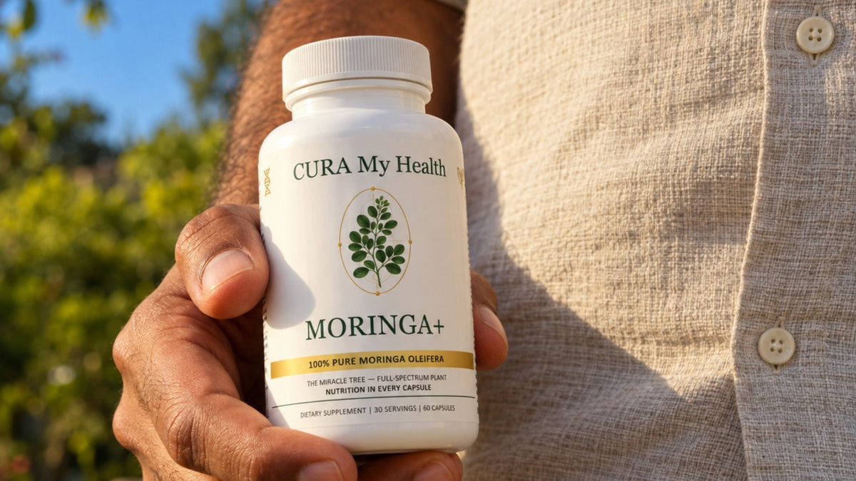 A hand holding a Moringa+ bottle outdoors