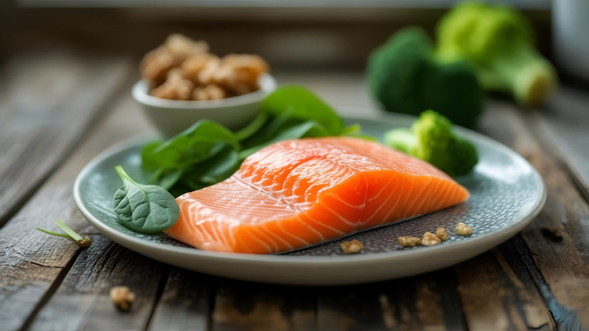 Salmon, spinach, broccoli and walnuts on a wooden table, foods that naturally contain CoQ10