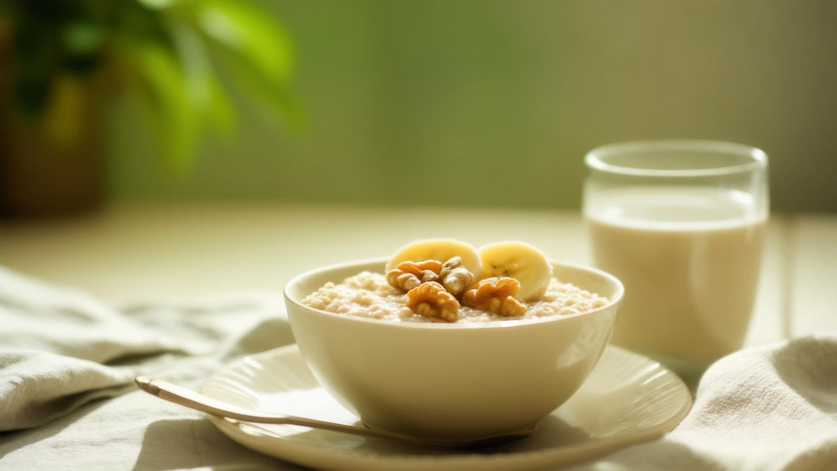 Oats with banana and walnuts and a glass of water on a bright breakfast table, steady daytime energy